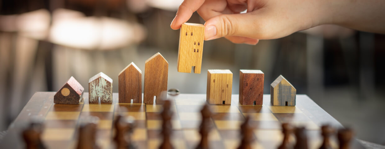 Building and house models in chess game, Business financial district and commercial , success and leadership business concept.